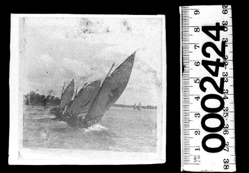 Three 22-footers on Sydney Harbour, one displaying a maltese cross emblem (possibly ESMERELDA) and another a crescent moon