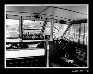 Print depicting interior of cabin cruiser looking forward