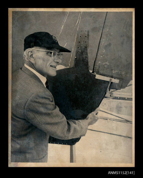 Sir Francis Chichester holding metal plating to be attached to a damaged keel GIPSY MOTH IV