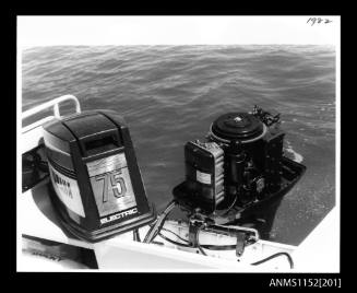 The image Yamaha 75 outboard engine mounted on boat with engine cover removed