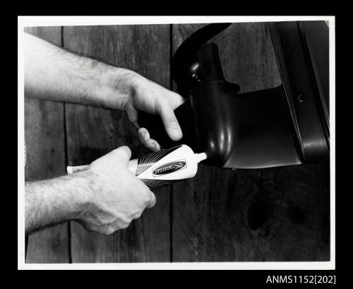 Hands holding a plastic tube of Iekhfaerer Mercury lubricating oil