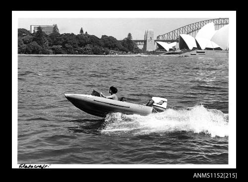 The small power boat unidentified at speed in Sydney Harbour