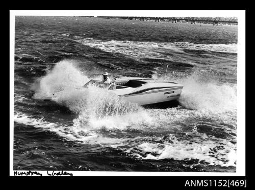 The Chrysler powered jet boat at speed through rough water