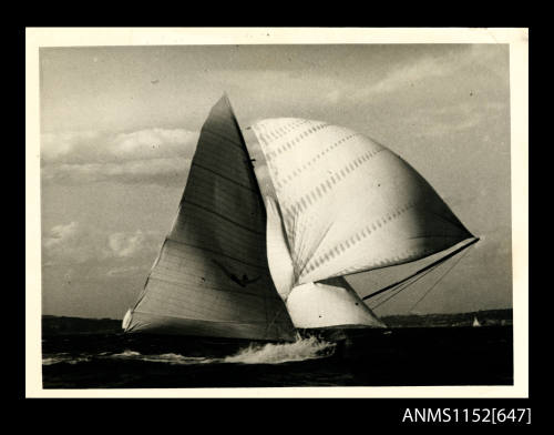 16-foot sailing boat, with jib and spinnaker set