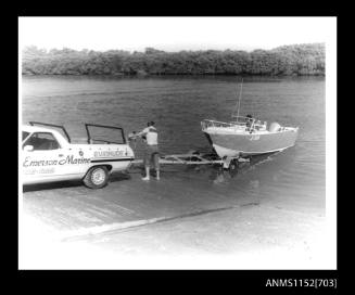 Emerson Marine's utility truck and trailer with open power boat JF98N