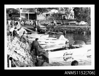 Speed boats ENID, FORE and ENTERPRISE MARINE moored along a stone embankment