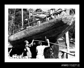 The single masted sailing boat with auxiliary engine on slipway cradle