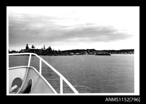 View across a stretch of water from bow of cabin cruiser 