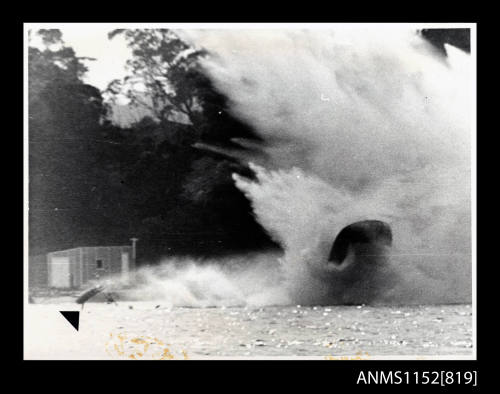 The racing hydroplane power boat in an almost vertical position of spray and foam