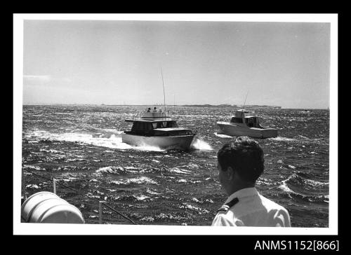 The two cabin cruisers unidentified passing each other in opposite directions