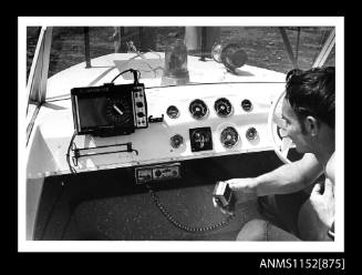 View into cockpit of vessel showing Marine Finder 100 depth finder and Weston two-way radio