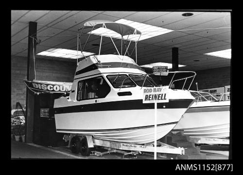 The boat showroom, displaying a cabin cruiser at centre starboard side view