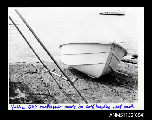 The image of dinghy of fibre-glass construction on a boat ramp