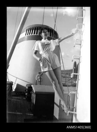 Model in playsuit aboard ship