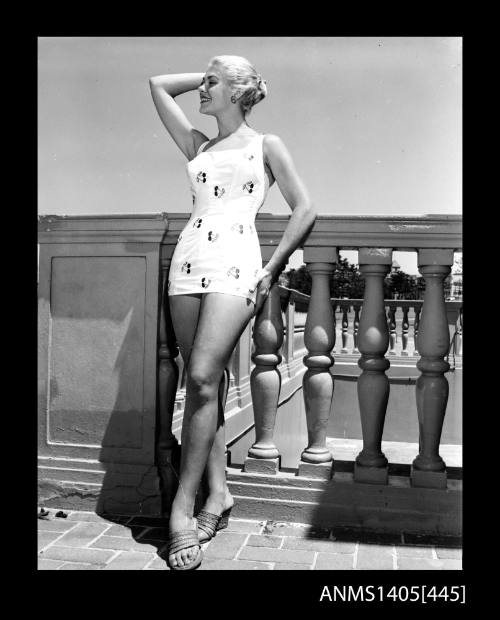 Model in cherry print swimsuit