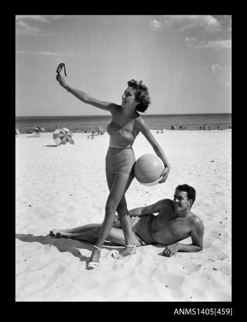 Couple modelling on beach in swimsuits