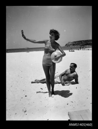 Couple on beach modelling swimwear