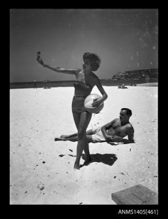 Couple on beach modelling swimwear