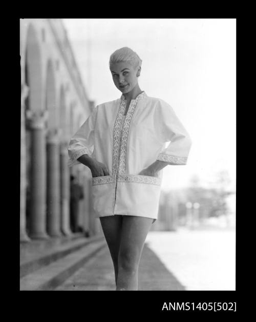 Model wearing white beach jacket at Bondi Pavilion