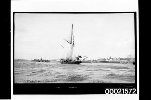 Two-masted schooner heading west passing Circular Quay