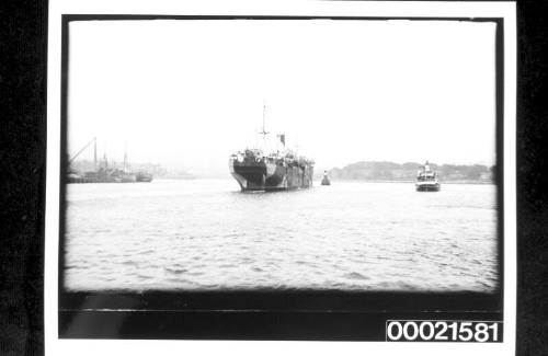 Armed merchant steamship in WWI dazzle camouflage being towed into Woolloomooloo