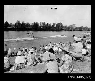 Negative depicting a water-ski event on a river, with spectators on the river bank