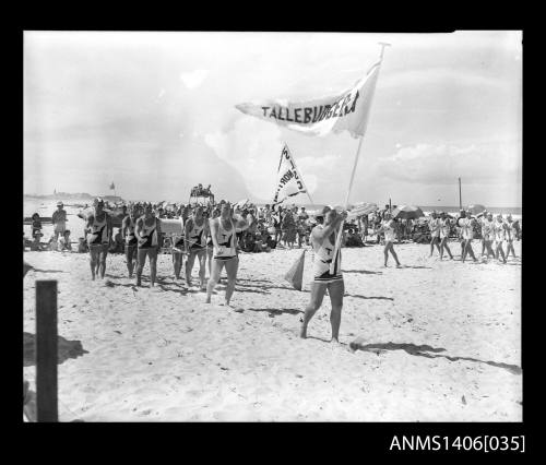 Negative depicting a surf life saver parade on a beach