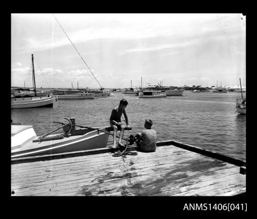 Negative depicting two adolescent boys on a jetty