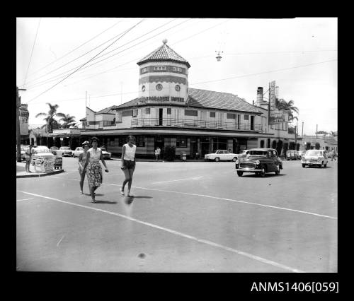 Negative depicting the Surfers Paradise Hotel and three women crossing at an intersection