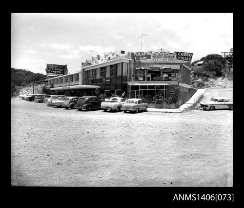 Negative depicting the Gold Coast Hotel with cars parked out the front