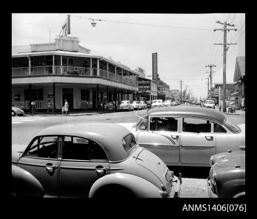 Negative depicting the Kirrabelle Hotel and cars in the main street of Surfers Paradise