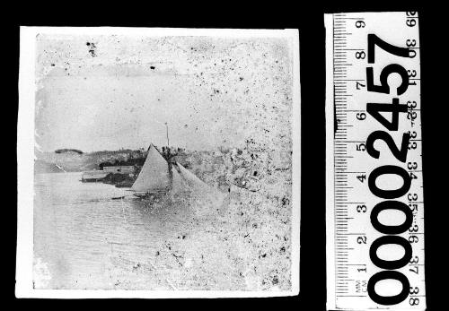 Badly damaged image of a cutter under sail on Sydney Harbour