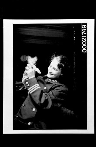 Female officer on a hospital ship holding a kitten