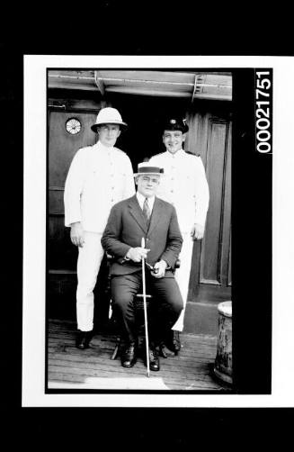 Three merchant mariners on deck of unidentified steamship