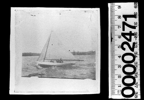 Port view of a white-hulled sloop under sail on Sydney Harbour with the crew visible in the vessel's cockpit.