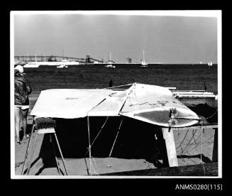 Mast and sail of PATIENT LADY III resting on trestles