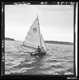 Vee Jay sailing dinghy on Middle Harbour with Grotto Point in background