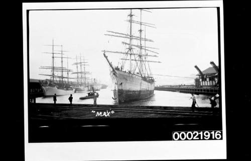 Three masted barque MAX berthing to wharf in harbour.