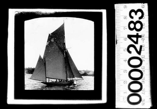 Starboard view of a yawl under sail near Fort Denison on Sydney Harbour