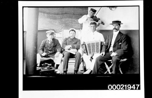 Group of officers relaxing and playing music on deck