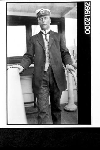 Merchant mariner standing on bridge ladder