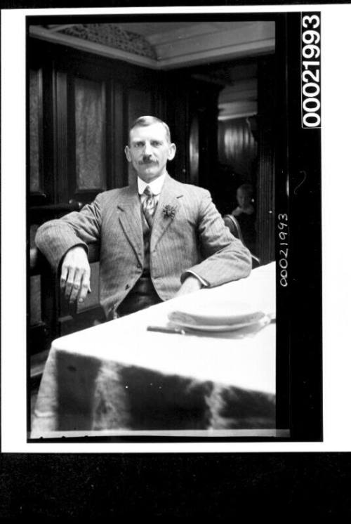 Merchant mariner sitting in saloon of vessel