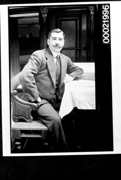 Merchant mariner sitting in saloon of vessel