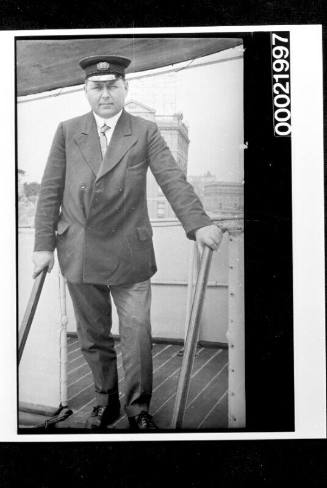 Merchant mariner standing on bridge of ship