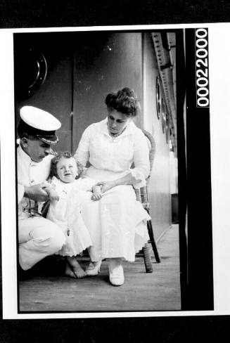 Captain with wife and child on board a vessel