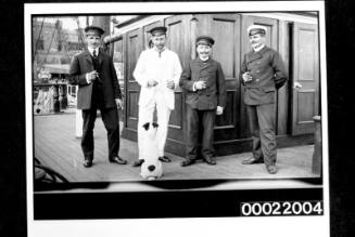 Captain and officers on a sailing ship with a pet dog