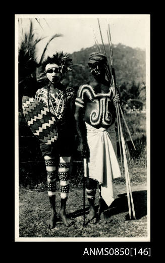 Two Palm Island men with body decoration, shield and spears