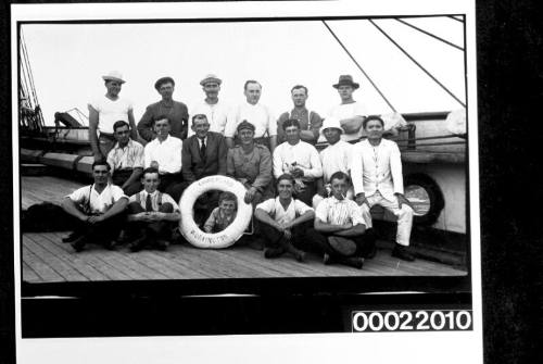 Group portrait of crew of sailing ship CUMBERLAND, with kitten