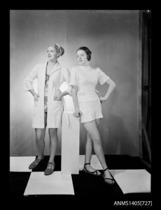 Negative depicting two women modelling beach wear