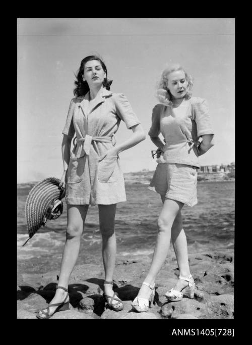 Negative depicting two women modelling beach wear